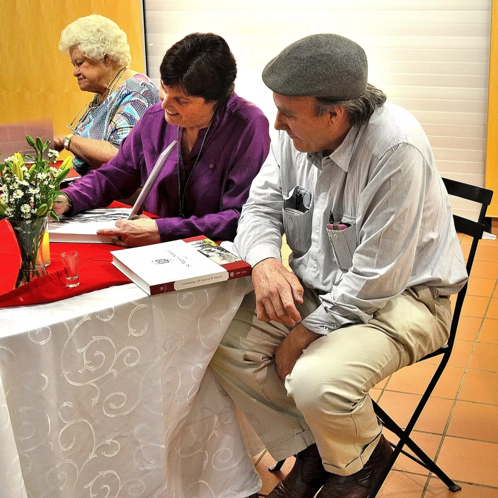 Pauline grainger author of celebrating 125 years of st mary signing copies of the book at the lauch