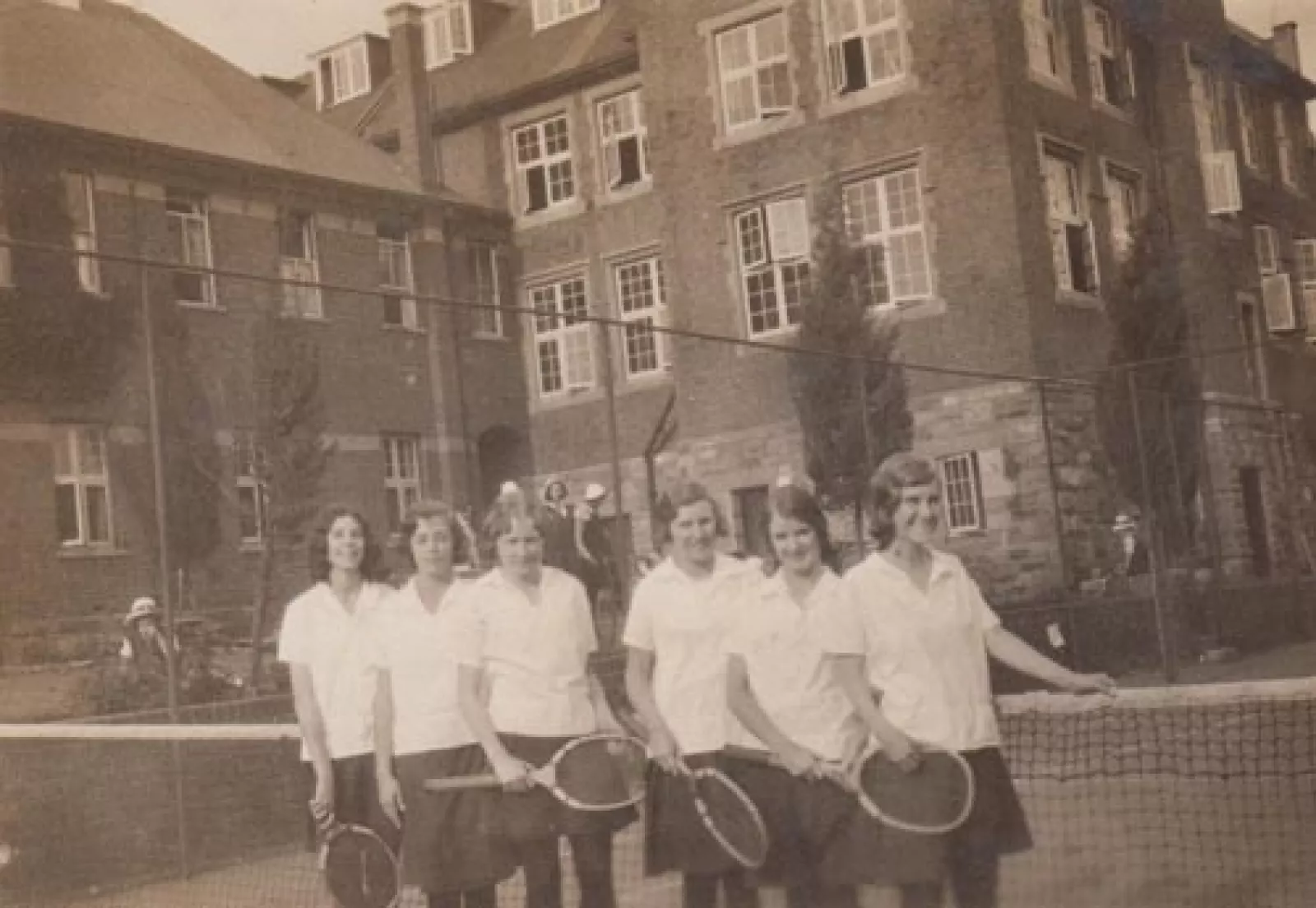 The buildings loom over the courts