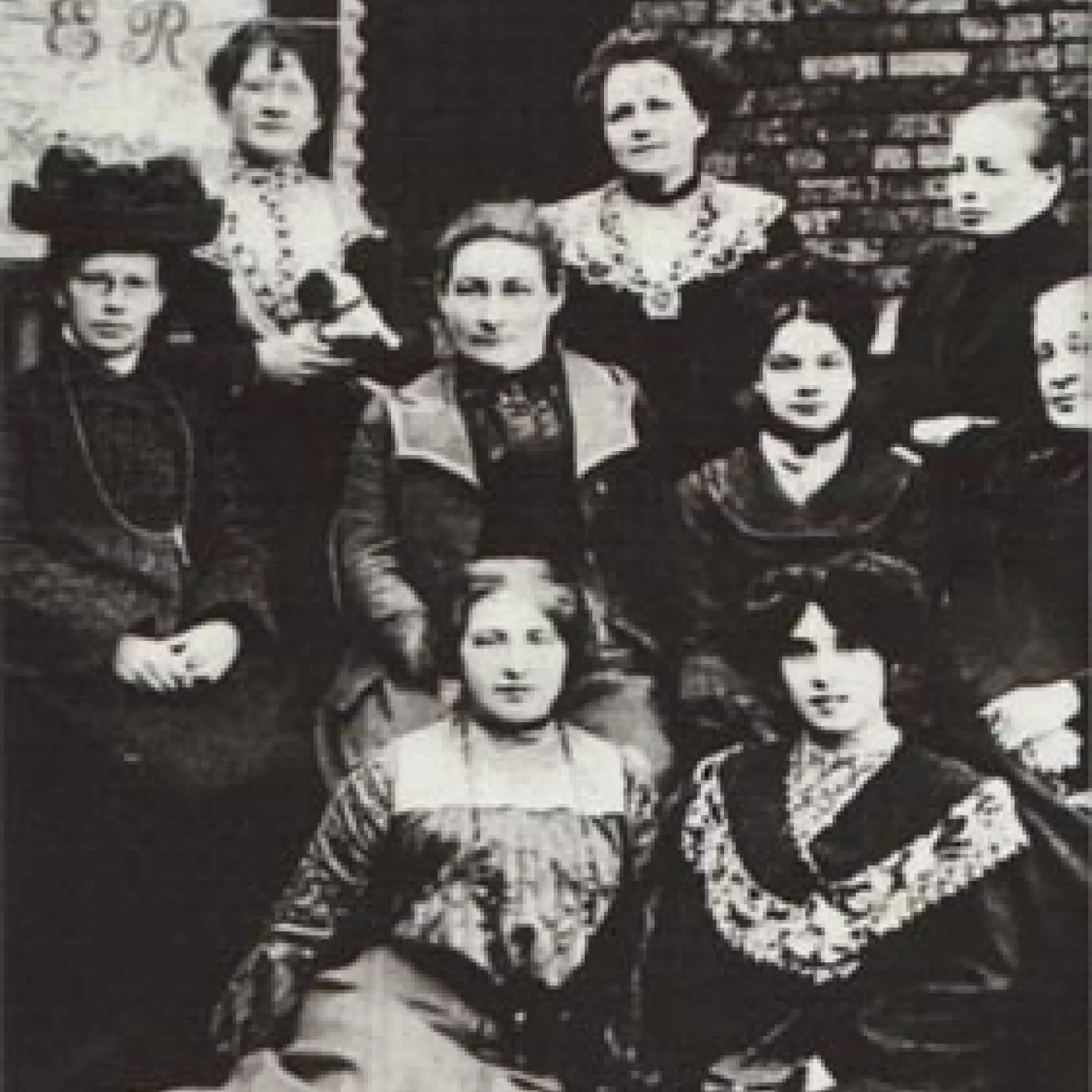 The e r on the banner behind s miss holmes orr centre and teachers stands for Yedward rex Y