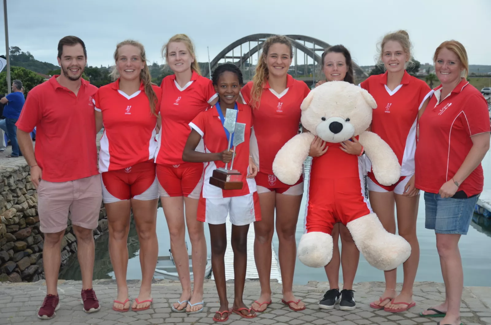 Boat race squad with their trophy and big red
