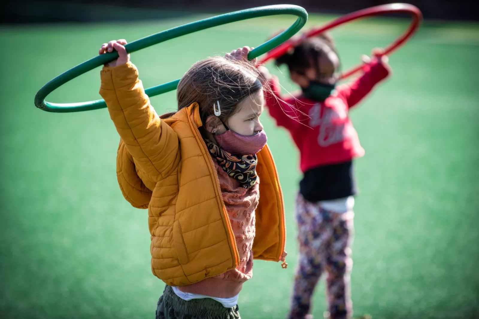 Children in Little Saints learning to play wearing a mask