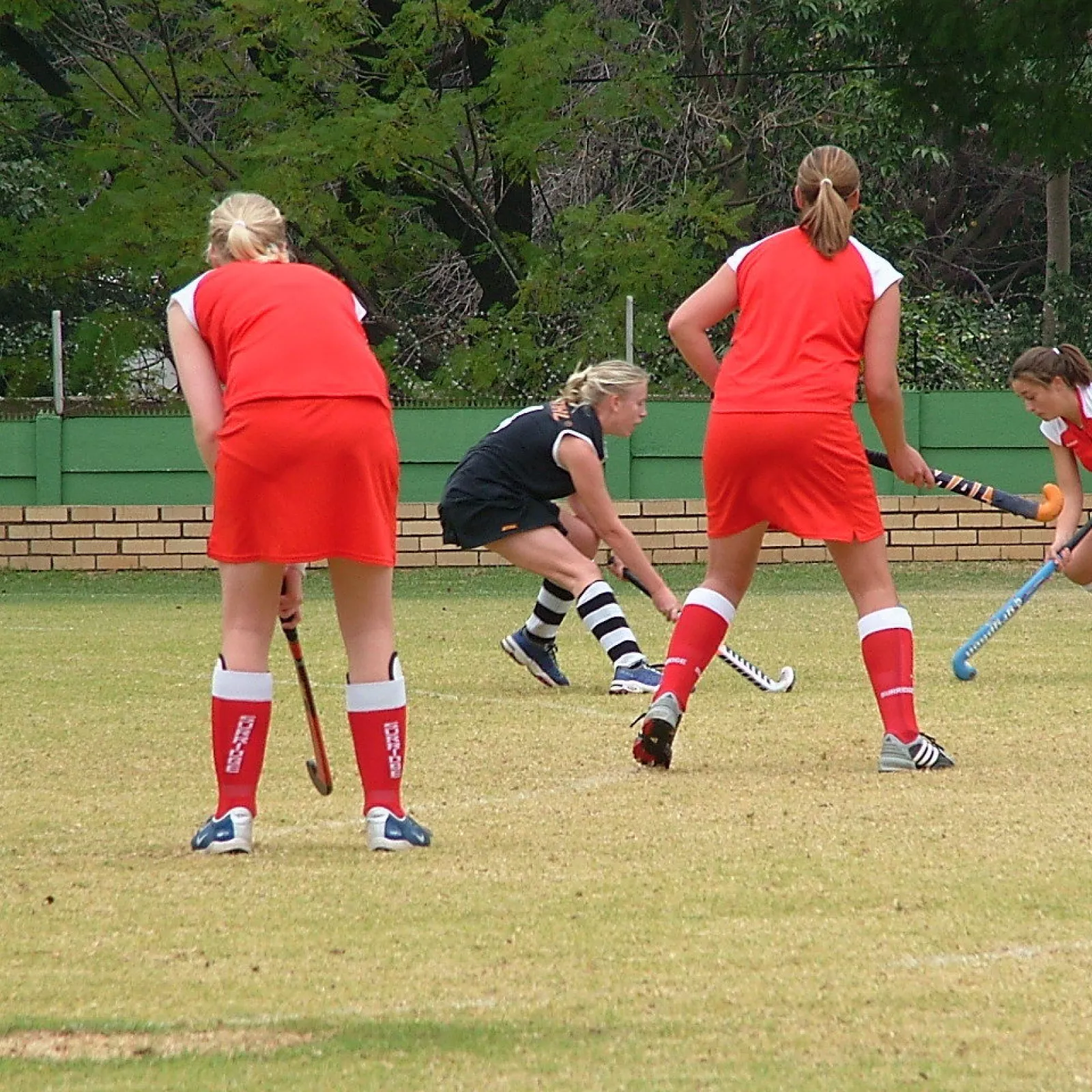 Girls playing hockey on the old field